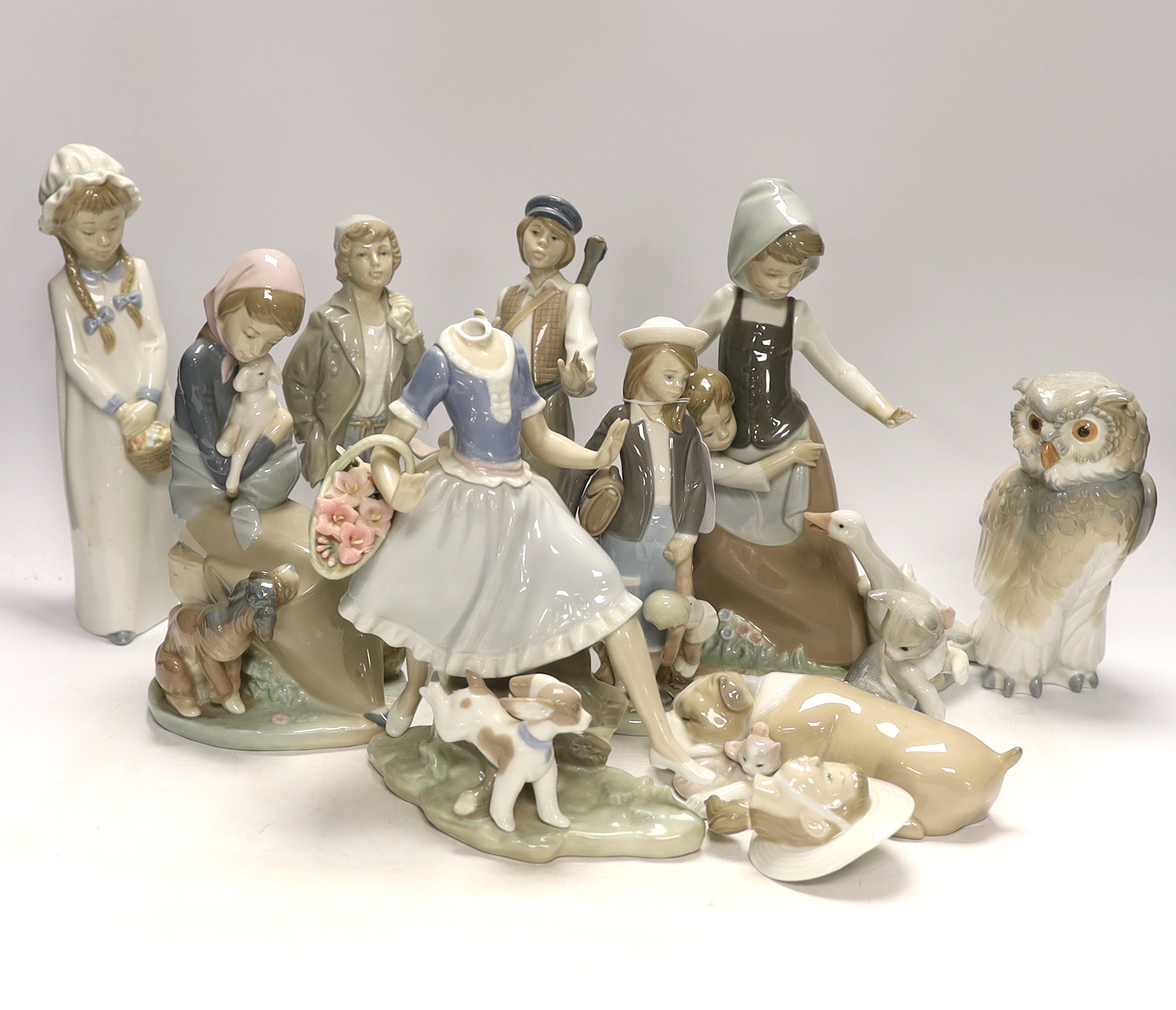 Ten Lladro and Nao figures including a short eared owl and a girl with braids, largest 26cm high